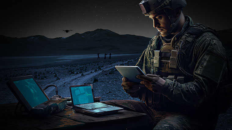 Soldier using handheld tech in the field